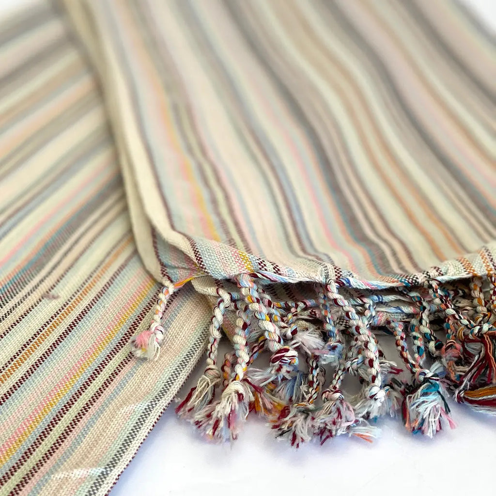 Woven cotton texture and tassels on soft pink Turkish towel