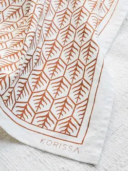 Folded natural cotton tea towel with tree motif