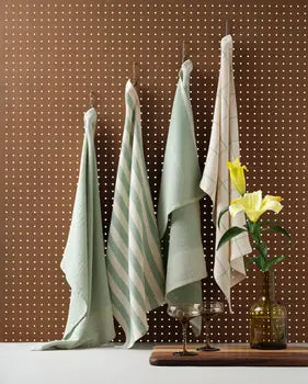 Sage green cotton kitchen towels in minimal and waffle weaves