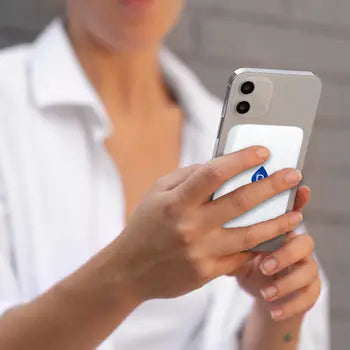 Magnetic wireless power bank attached to a compatible phone